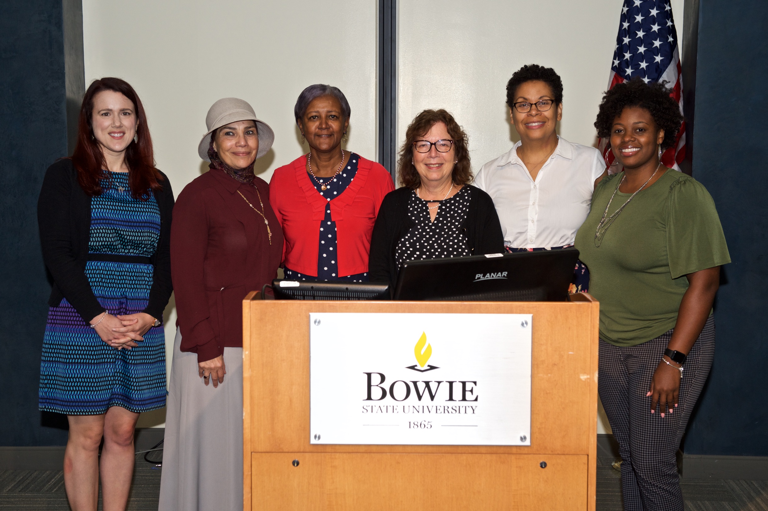 Portrait of the first cohort of CETL Fellows standing behind a Bowie State University podium