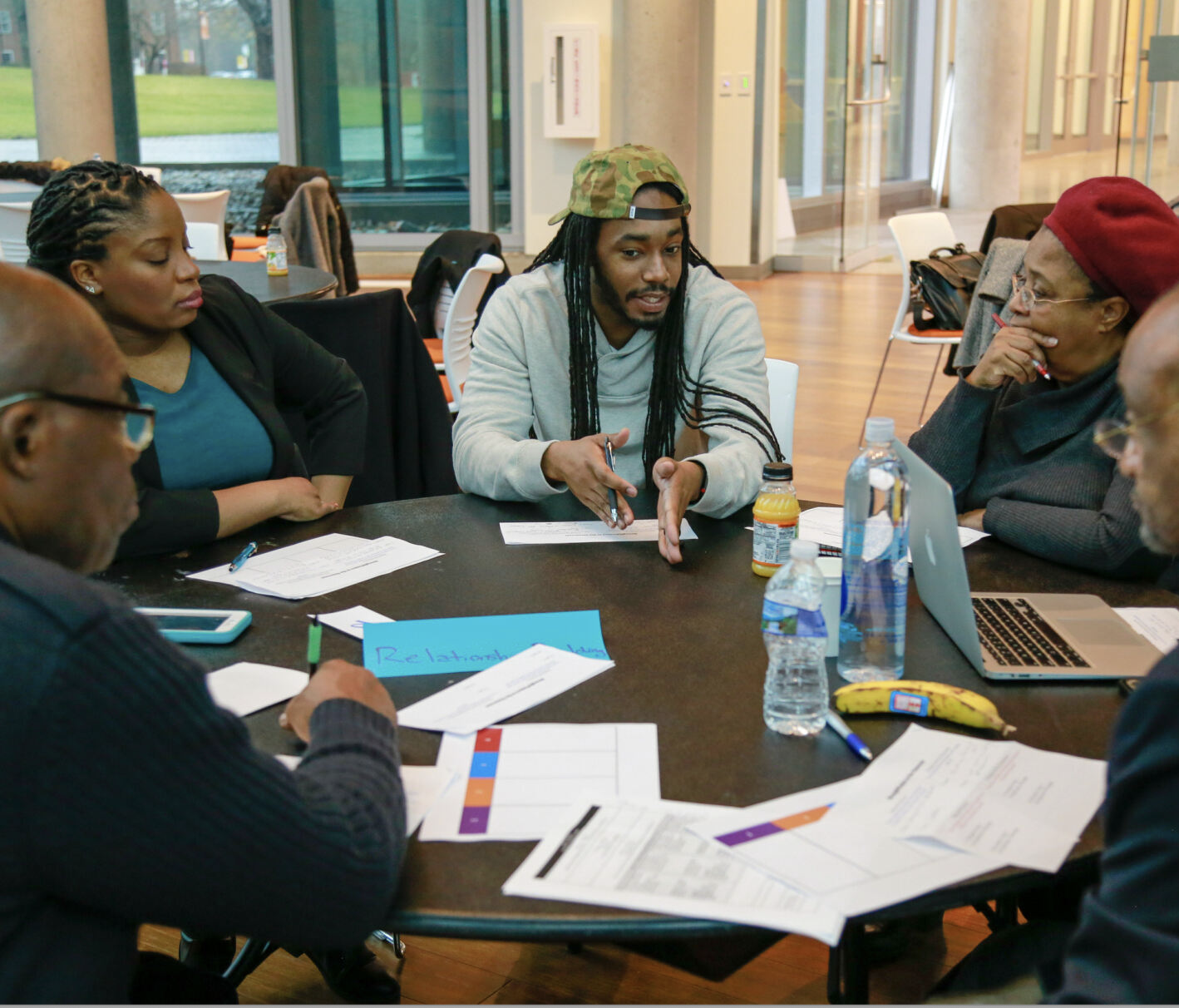 Group of faculty around a table in discussion