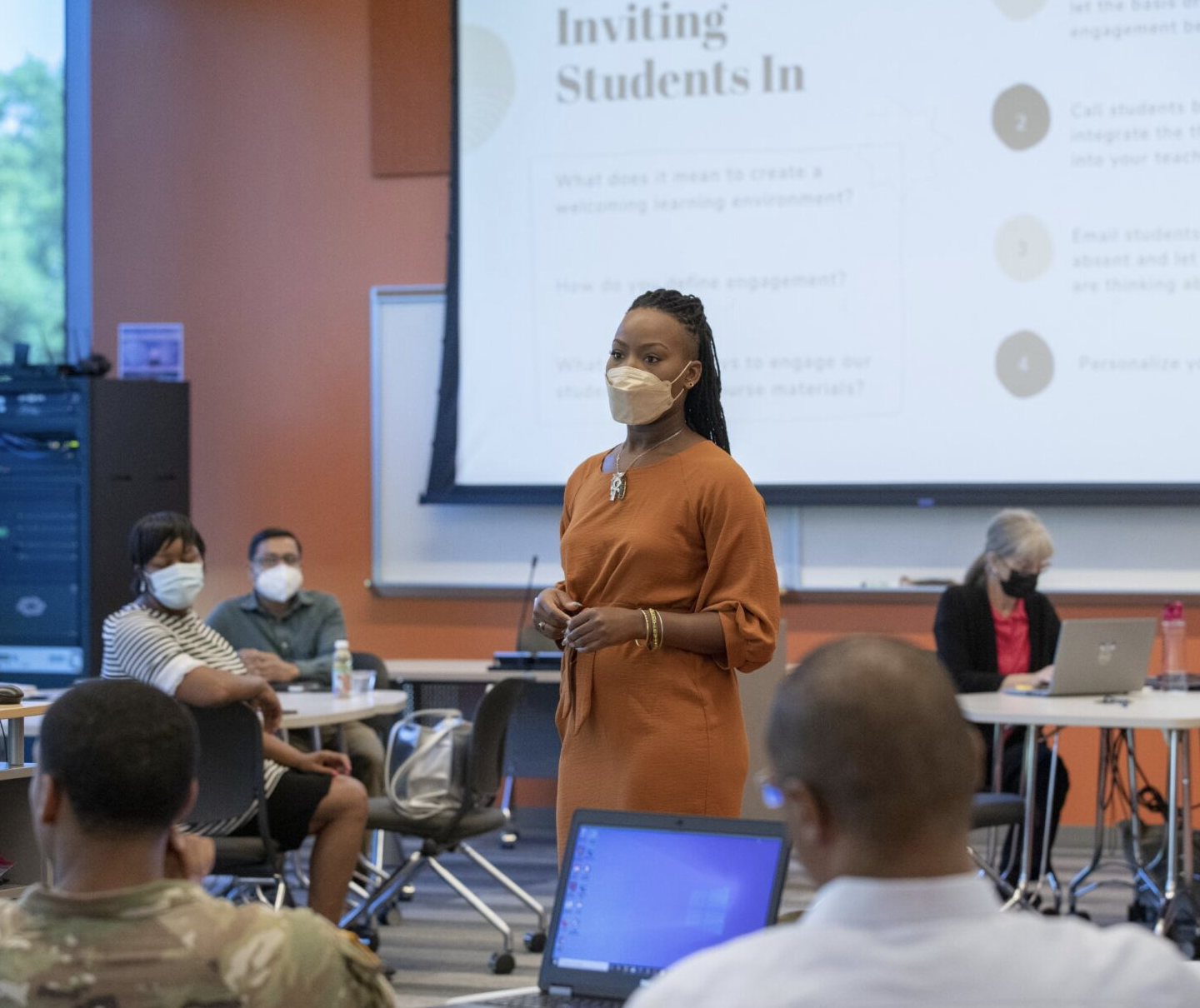 Instructor leading faculty in a session title "Inviting Students In"