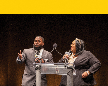 man and woman at podium speaking