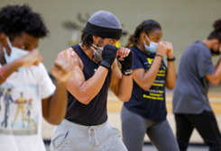 four people in a boxing stance. 