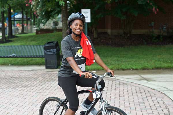 Female cyclist rides on the campus
