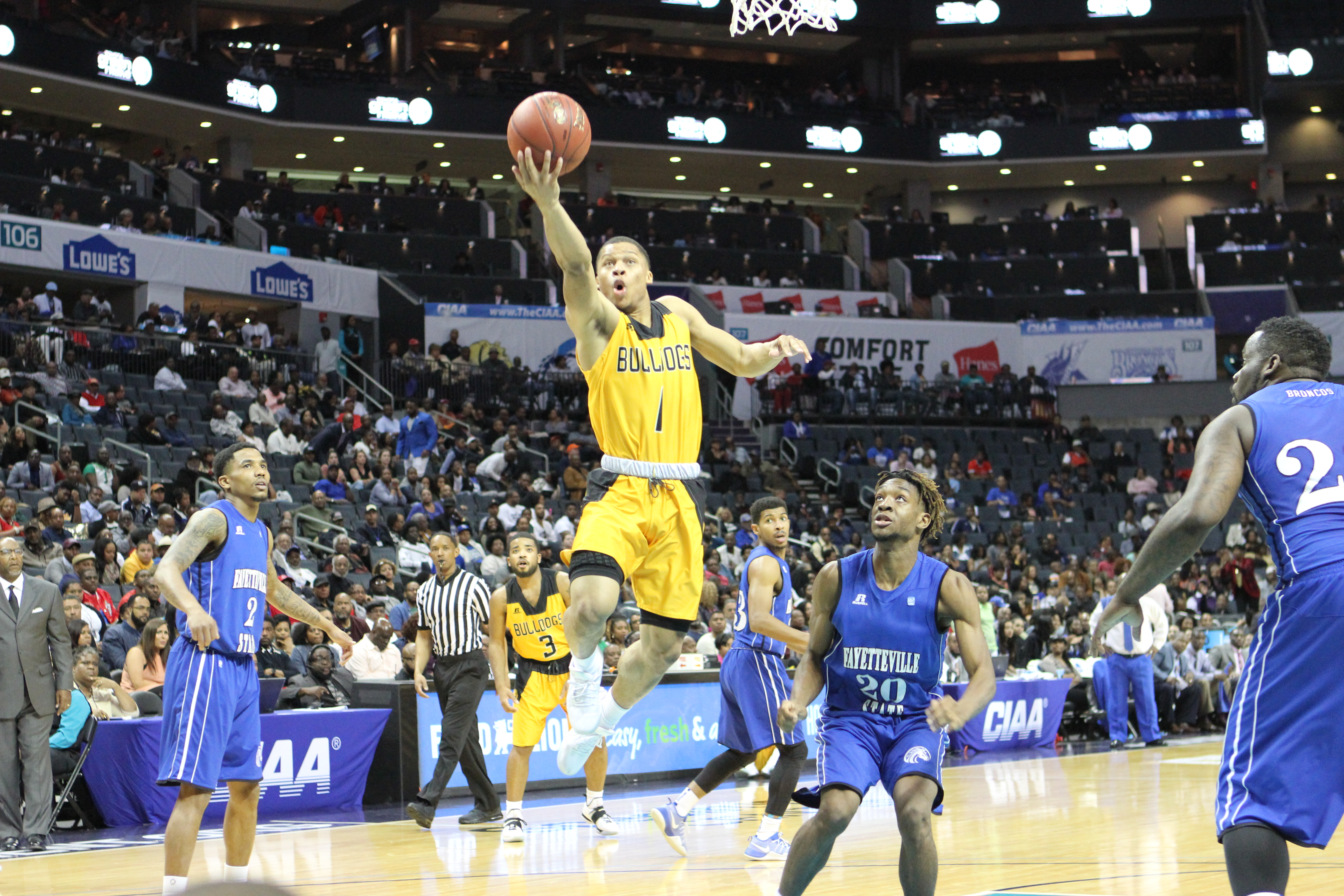 Dayshawn Wells drives toward the basket