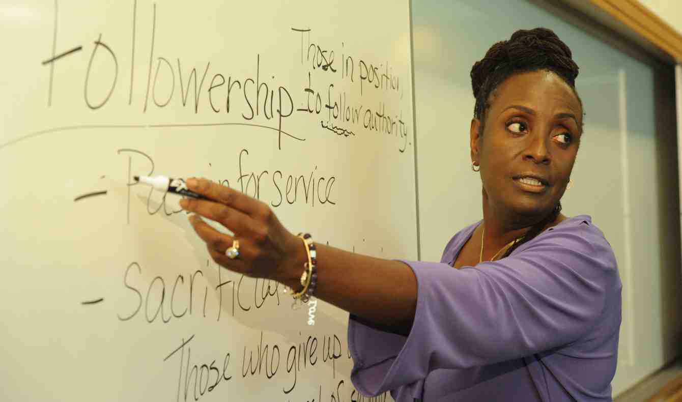 Wendy Edmonds points to a white board where the word Followership and an explaination of it is written