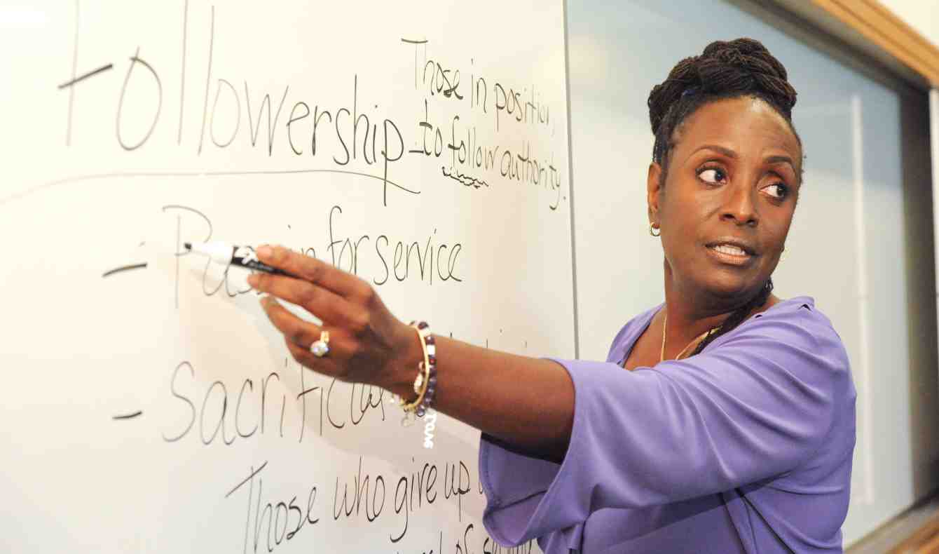 Wendy Edmonds points to a white board where the word Followership and an explaination of it is written