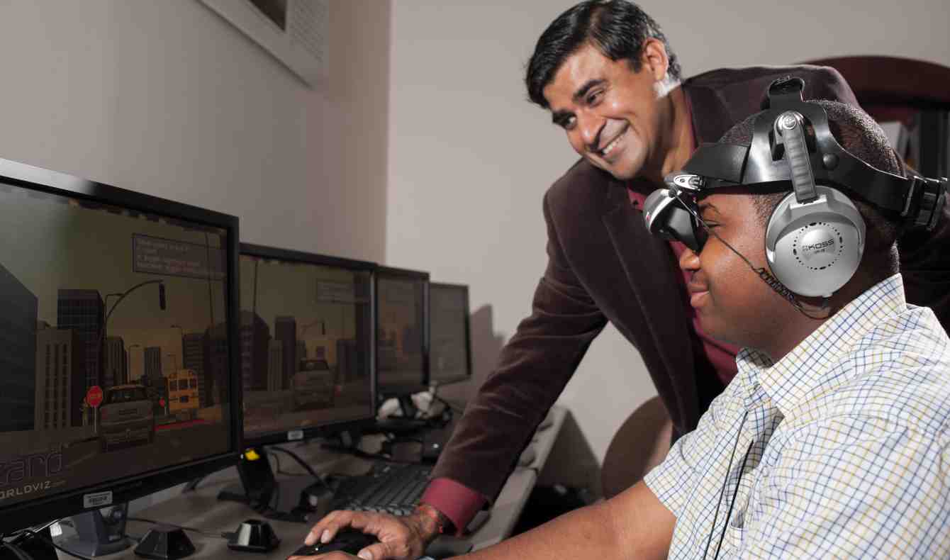 Sharad Sharma works with student on virtual reality project